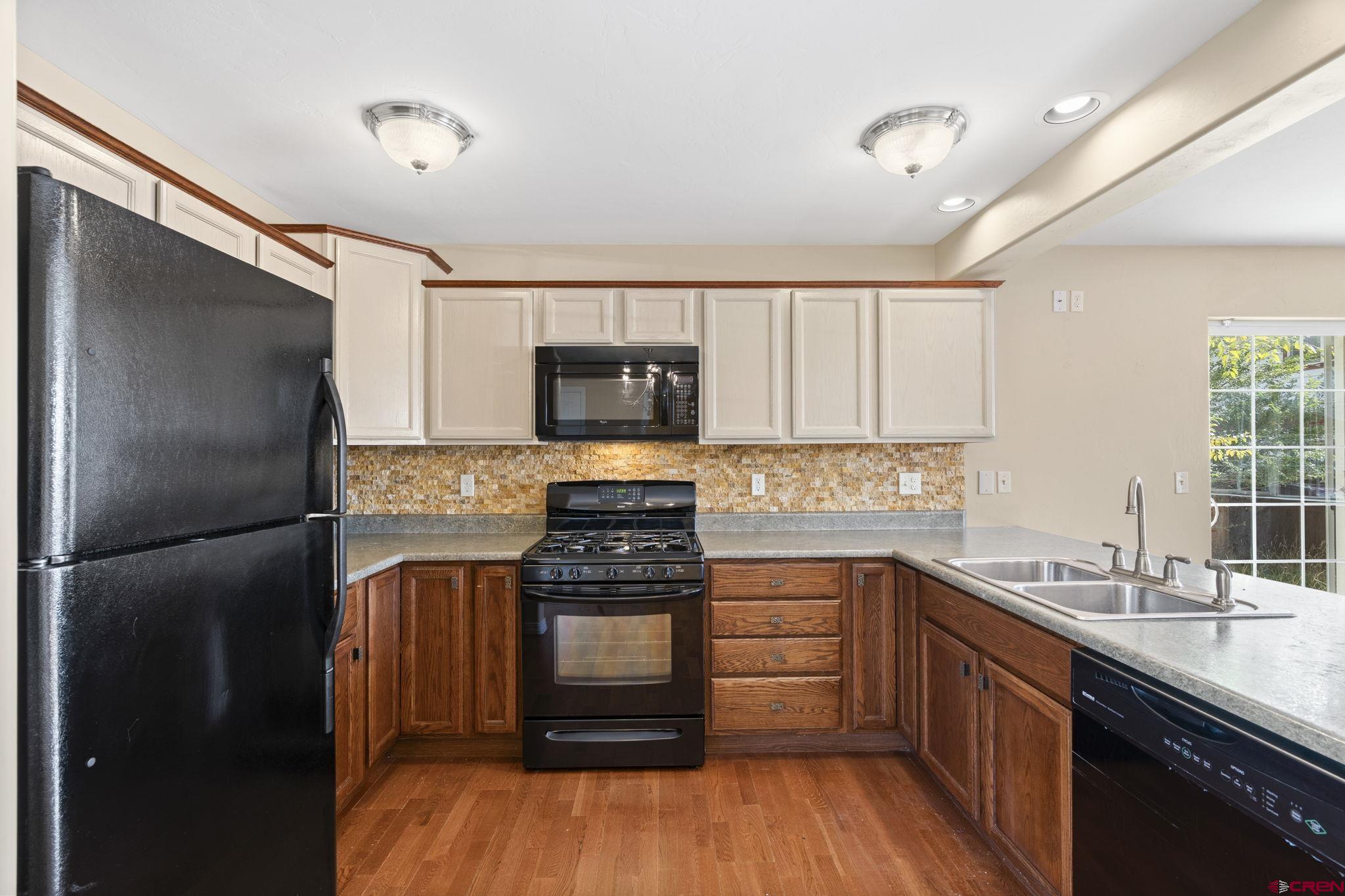 724 Jacobs Lane Bayfield, CO 81122 - Photo 7 of 33 a kitchen with a sink stove and refrigerator