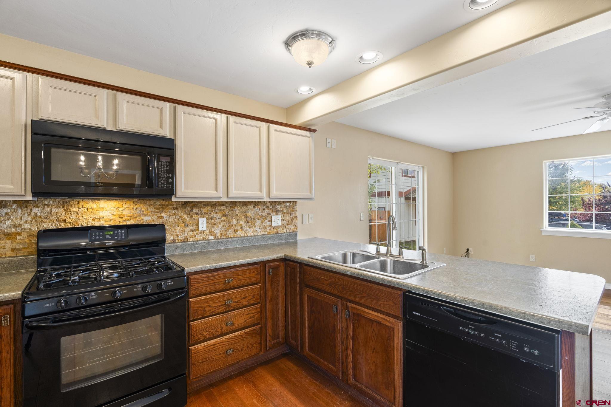 724 Jacobs Lane Bayfield, CO 81122 - Photo 8 of 33 a kitchen with stainless steel appliances granite countertop a stove microwave and sink