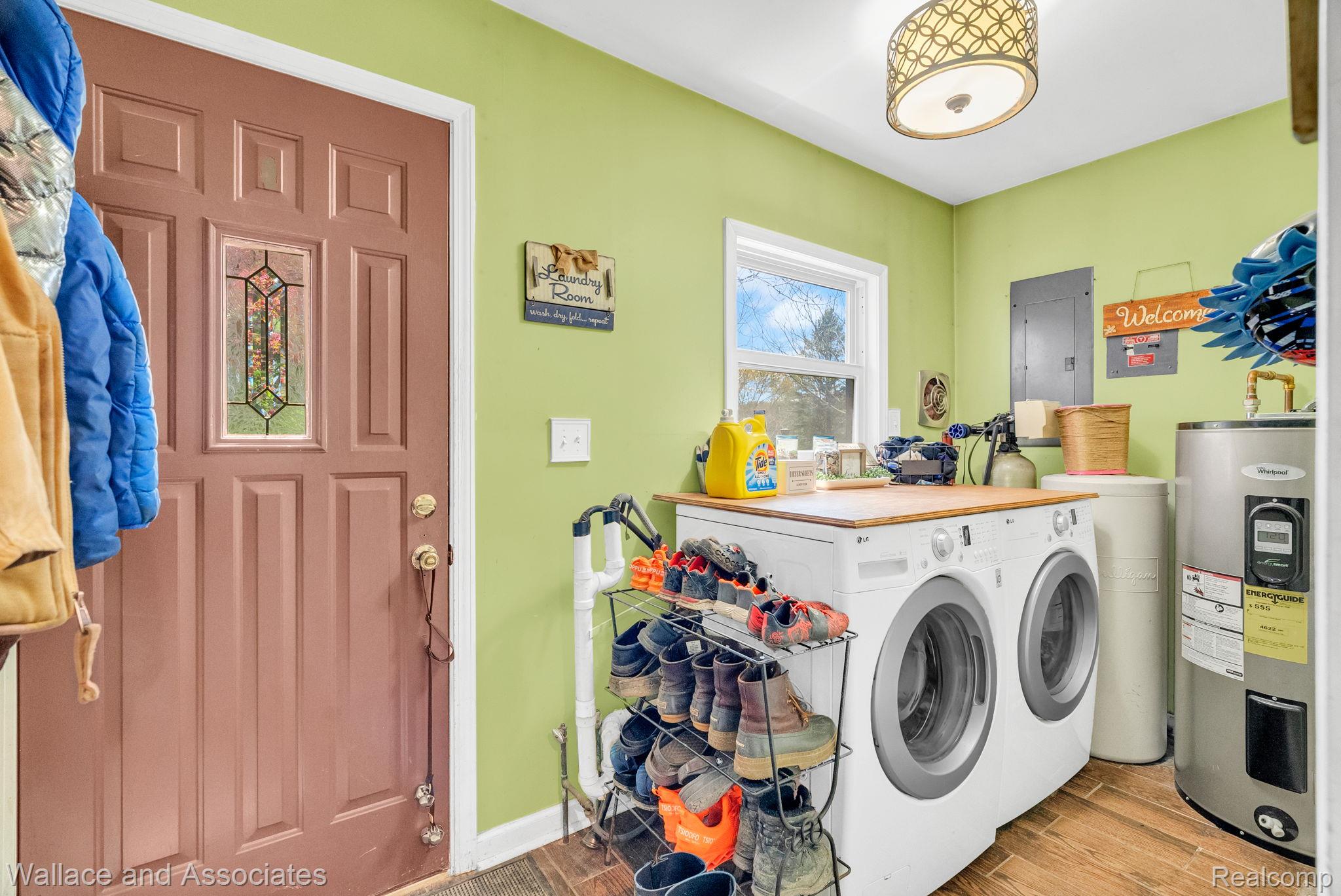 6616 Wellman Line Road Croswell, MI 48422 - Photo 29 of 47 Laundry area featuring water heater, independent washer and dryer, wood tiled floors, and electric panel
