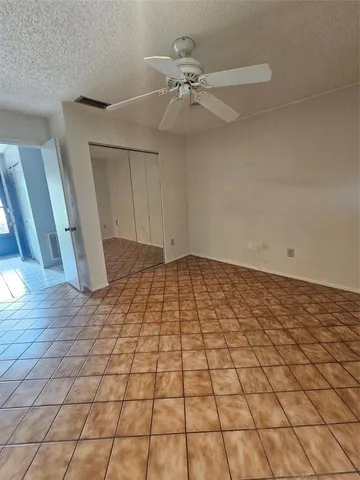 a view of an empty room and wooden floor