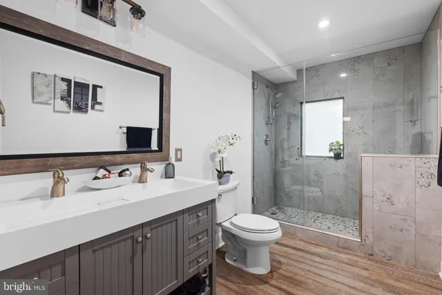 a bathroom with a glass shower door