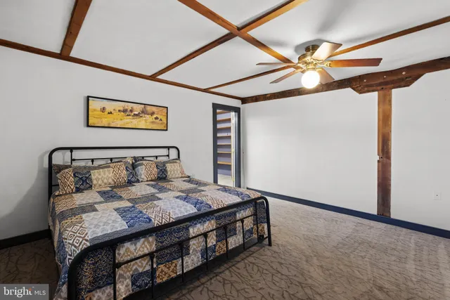 a bed sitting in a bedroom next to a window