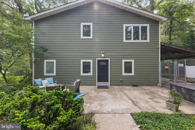 an aerial view of a house with a yard and outdoor seating