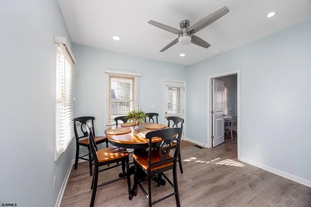 a view of a dining room with furniture and a window