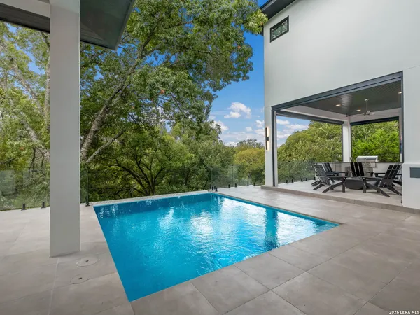 a view of a swimming pool with a lounge chair
