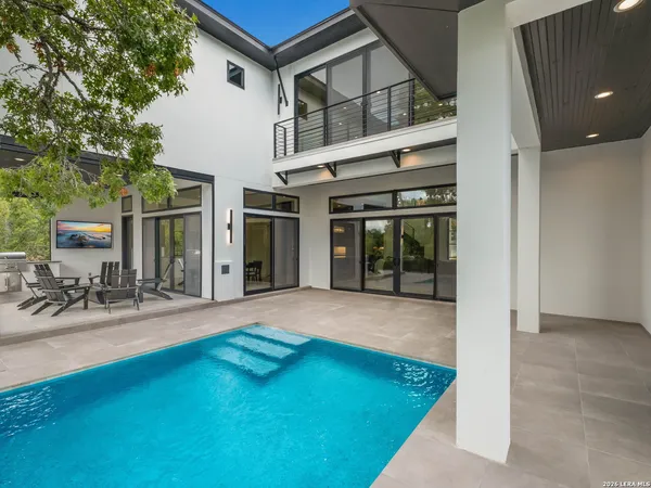 a view of a house with backyard porch and sitting area