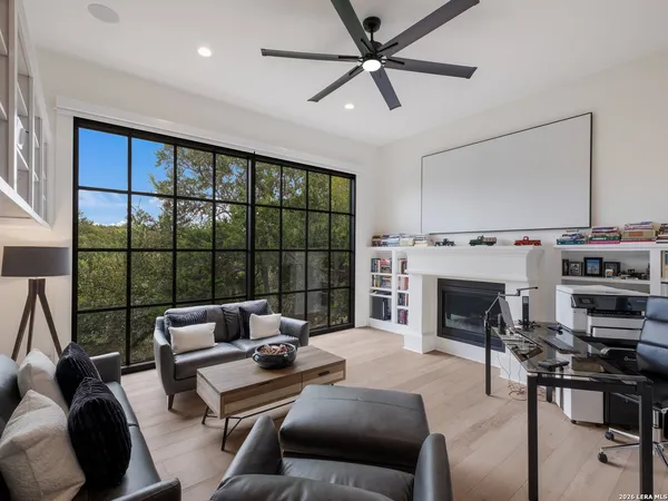 a living room with furniture a flat screen tv and a fireplace