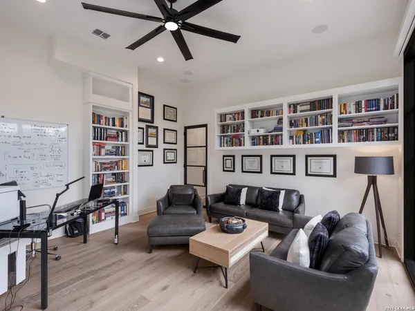 a living room with furniture and a book shelf