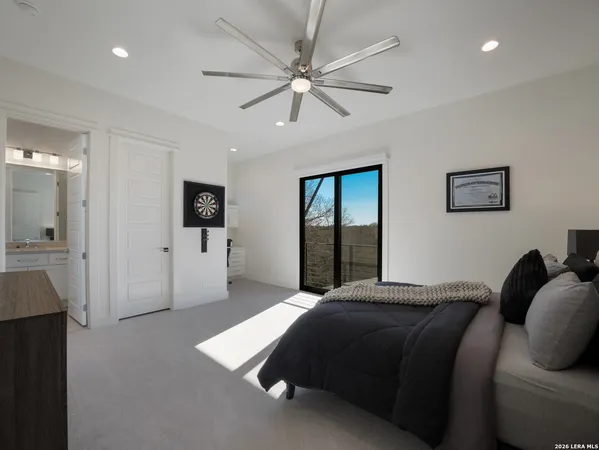 a bedroom with a large bed and a chandelier