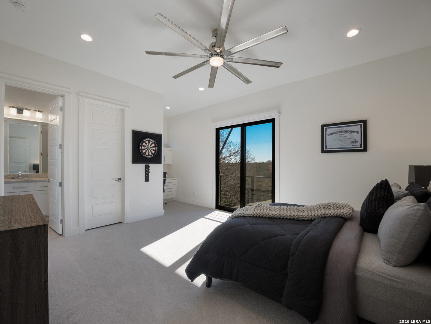 1053 Brewer Rdg Road Bulverde, TX 78163 - Photo 20 of 37 a bedroom with a large bed and a chandelier