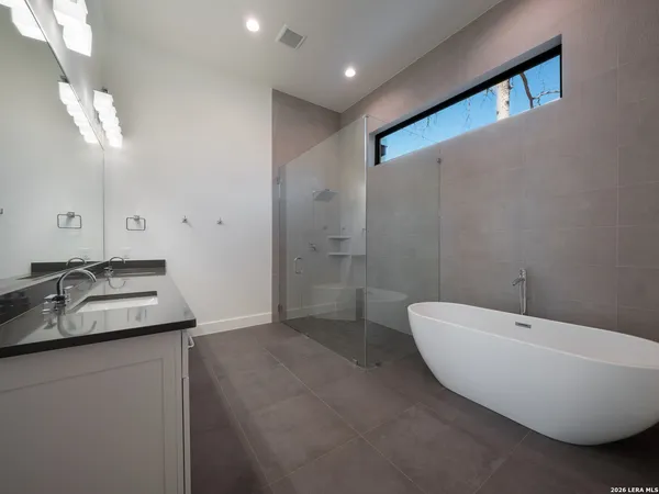 a bathroom with a double vanity sink and a bathtub