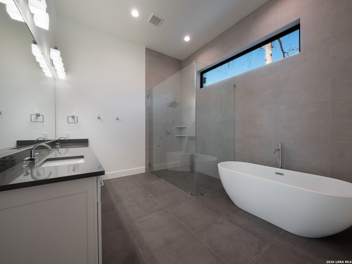 1053 Brewer Rdg Road Bulverde, TX 78163 - Photo 21 of 37 a bathroom with a double vanity sink and a bathtub