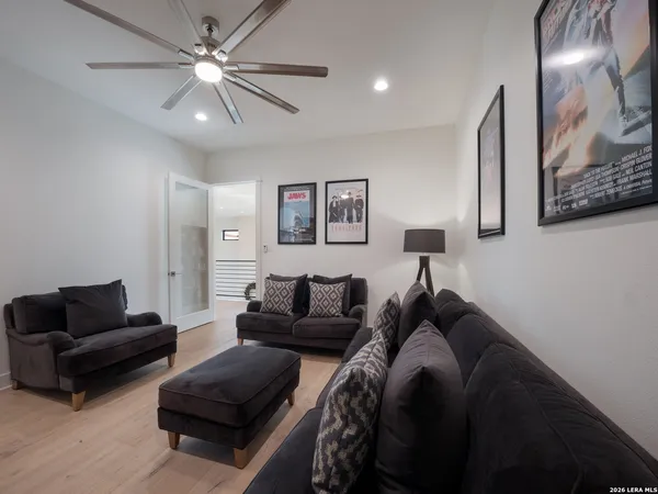 a living room with furniture and a ceiling fan