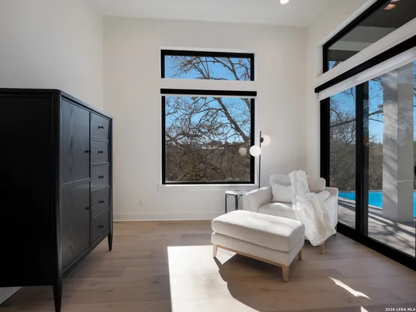 a living room with furniture a large window and a glass door