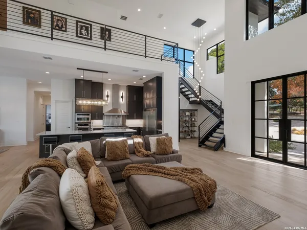 a living room with furniture and stairs
