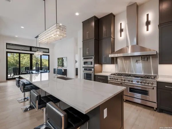 a kitchen with a stove a refrigerator and a dining table
