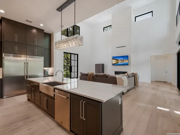 a kitchen with stainless steel appliances a sink and a refrigerator