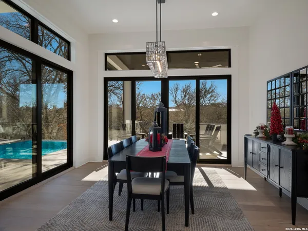 a view of a dining room with furniture wooden floor and a chandelier