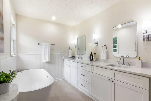 a bathroom with a white toilet a sink and a mirror