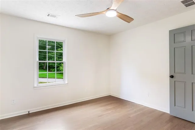 a bathroom with a sink a toilet and a window