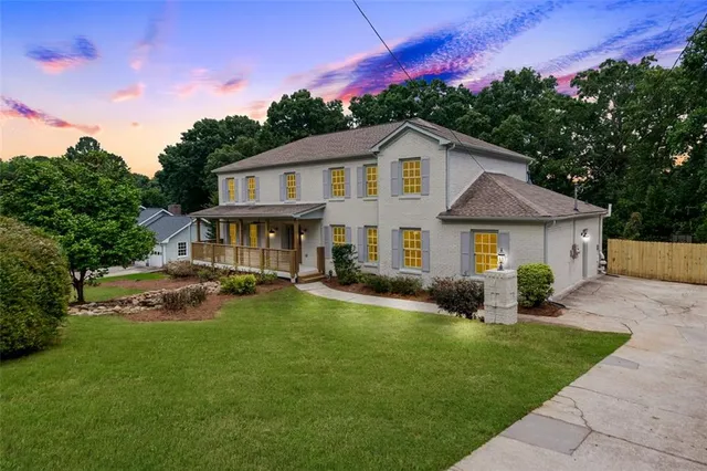 a front view of a house with a yard table and chairs