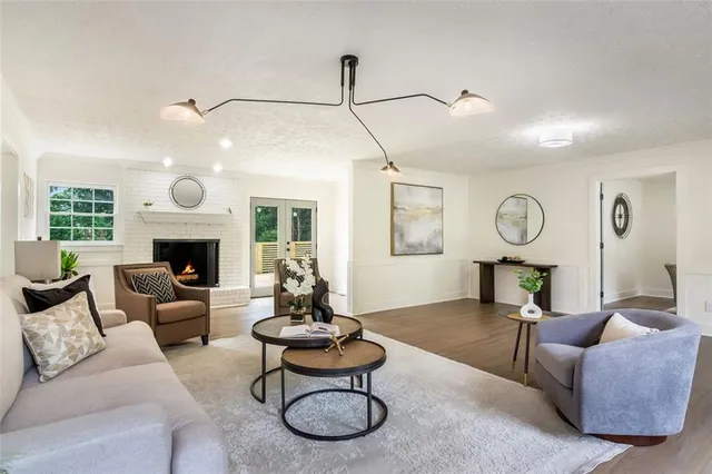 a living room with furniture a fireplace and window