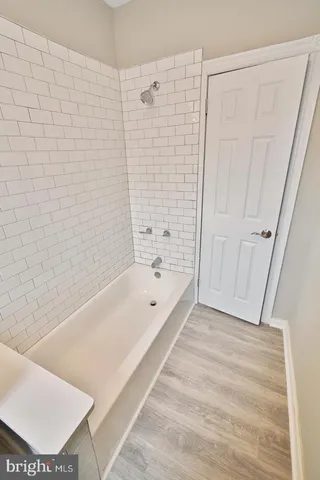 a bathroom with a tub a toilet and a shower