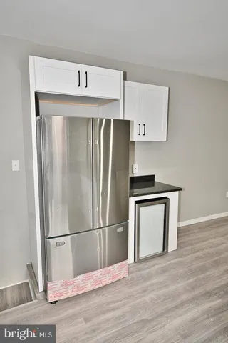a kitchen with a refrigerator and a sink