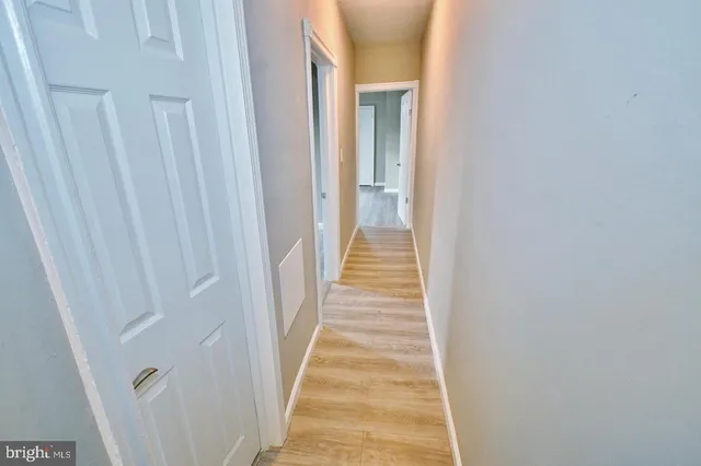 a view of a hallway with a white door