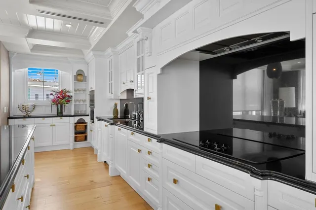 a kitchen with stainless steel appliances granite countertop a sink a stove oven a counter top space and cabinets