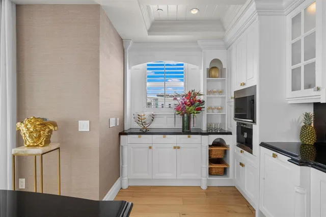 a large kitchen with stainless steel appliances lots of counter space and a sink
