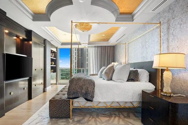 a bedroom with a bed and a chandelier