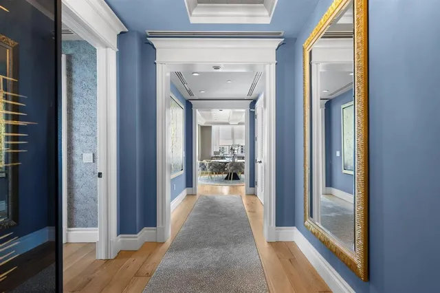 a dining room with furniture a kitchen and chandelier