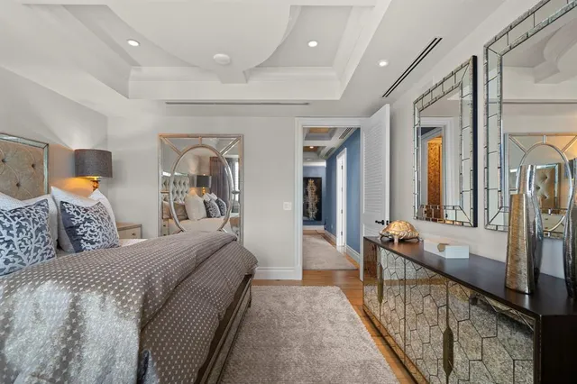 a bedroom with a large bed and a chandelier