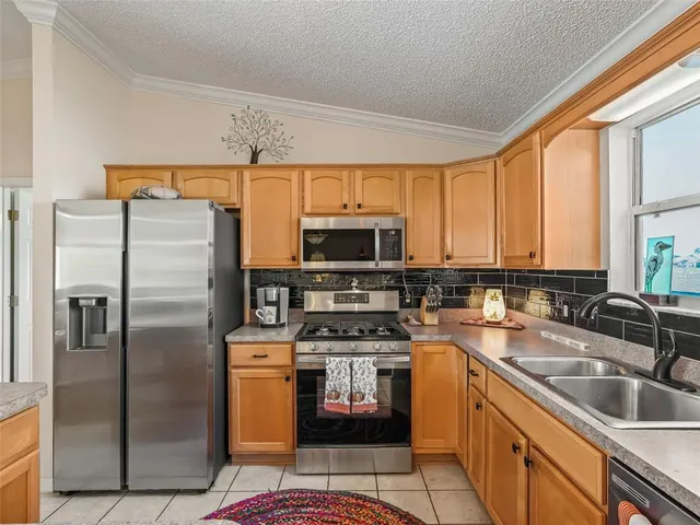 a kitchen with a refrigerator sink and stove