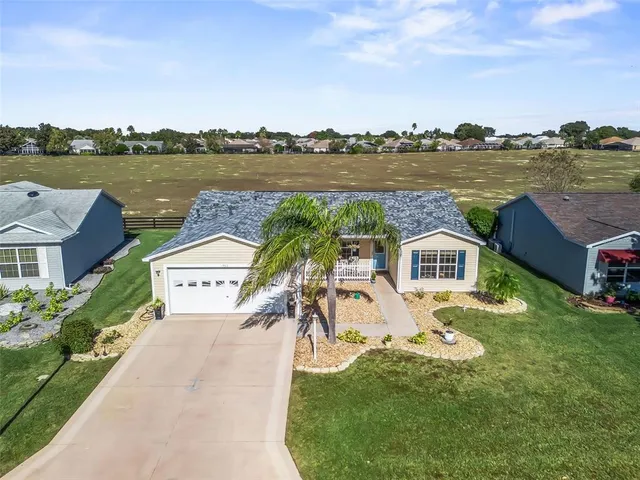 an aerial view of a house with outdoor space and lake view