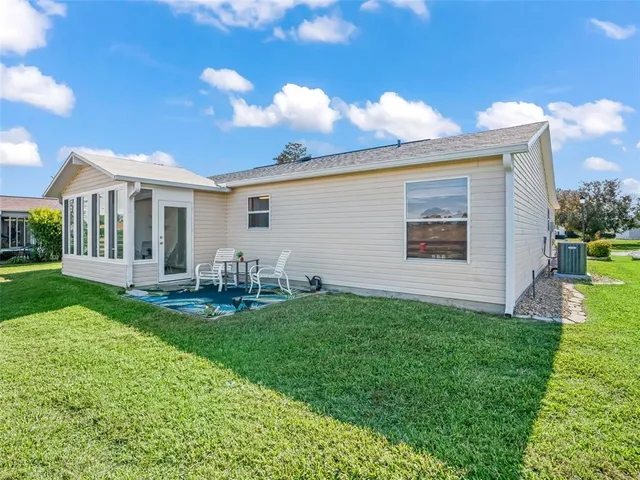 a view of a house with backyard porch and sitting area