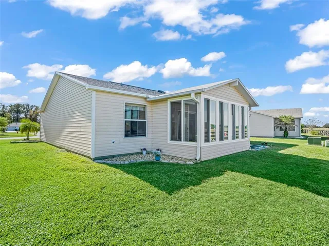 a view of a house with a yard and porch