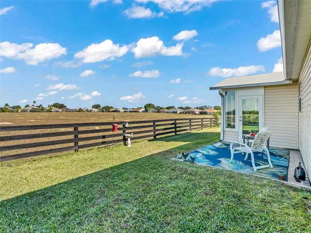 a view of a house with a yard porch and sitting area