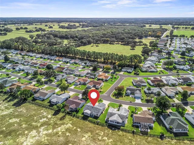 an aerial view of residential houses with outdoor space and swimming pool