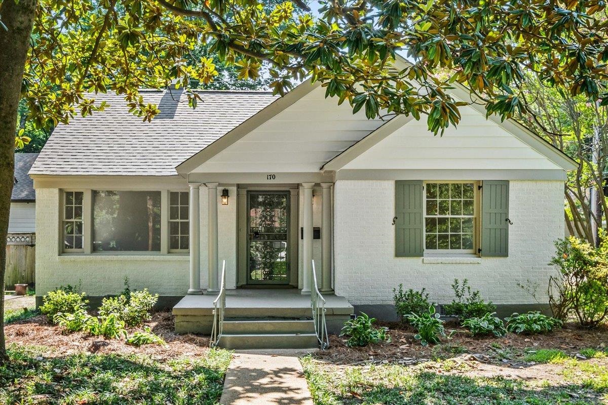 170 South Greer Street Memphis, TN 38111 - Photo 1 of 35 White brick exterior with a grey shingle roof and a covered front porch featuring white columns