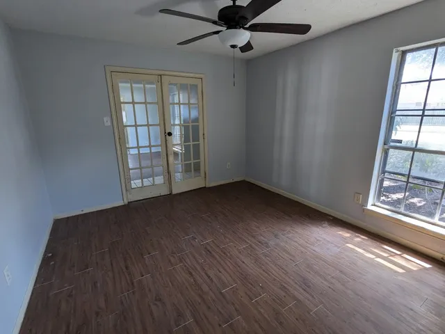wooden floor in an empty room with a window