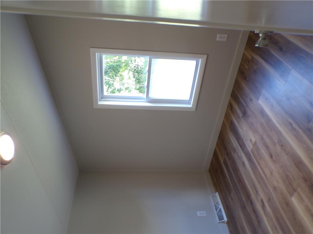 7877 Gun Club Road New Tripoli, PA 18066 - Photo 9 of 19 Natural light filters through the skylight, illuminating the pristine hardwood flooring below.