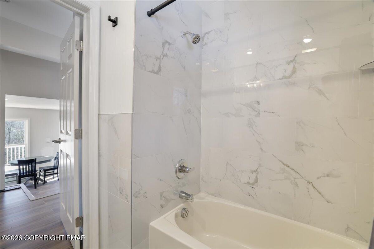 5873 Decker Road Bushkill, PA 18324 - Photo 21 of 57 a bathroom with a bathtub and a shower