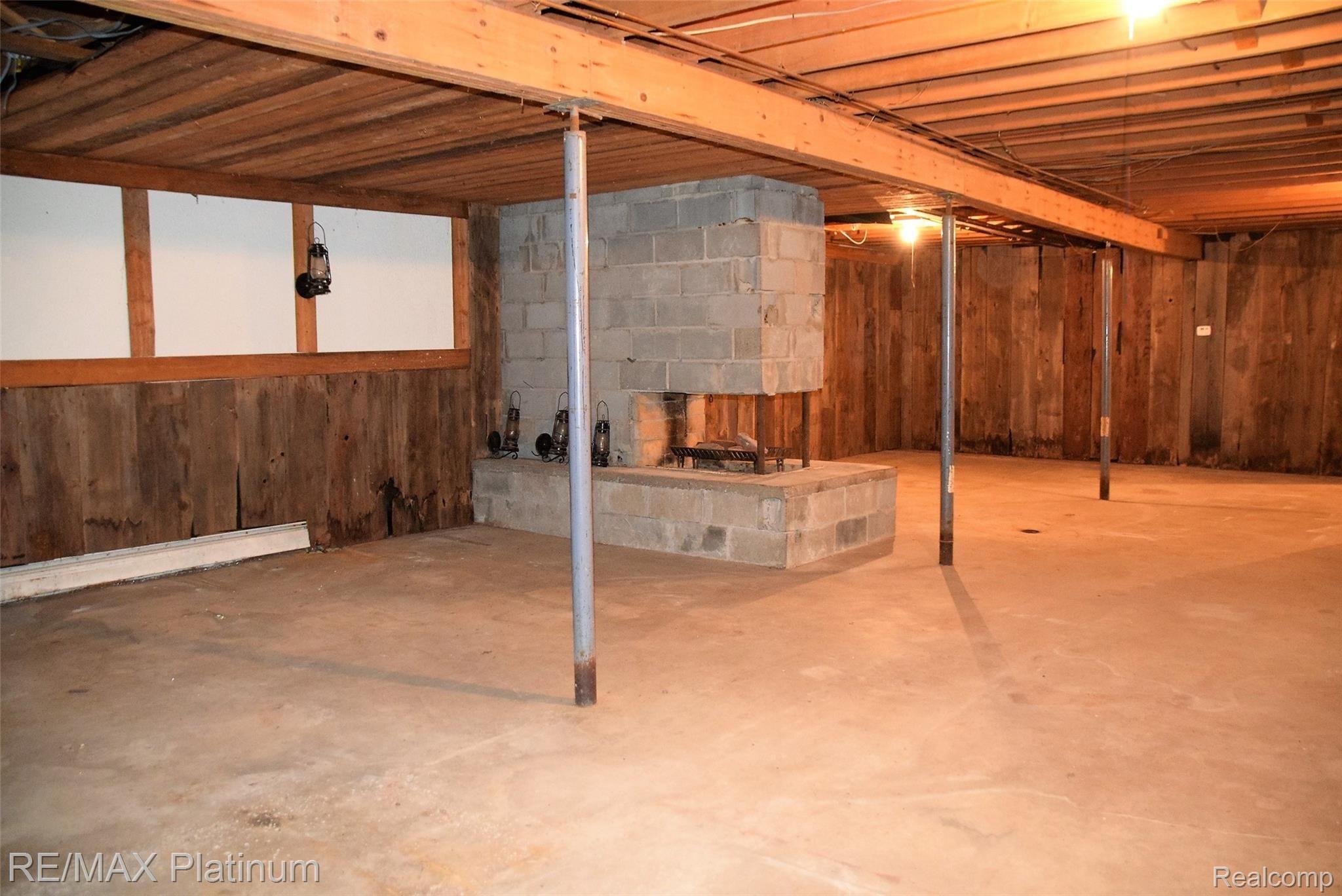 7525 Fisher Road Howell, MI 48855 - Photo 27 of 54 basement wood walls fireplace.JPG