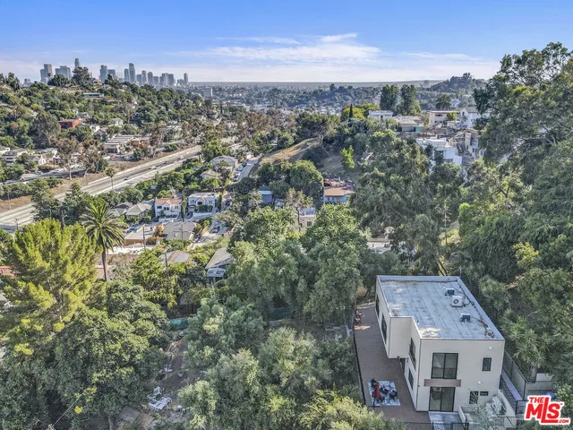 an aerial view of residential houses with city view