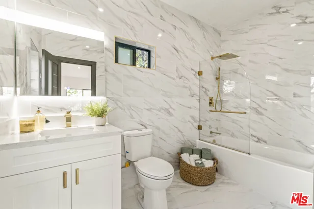 a bathroom with a sink mirror and window
