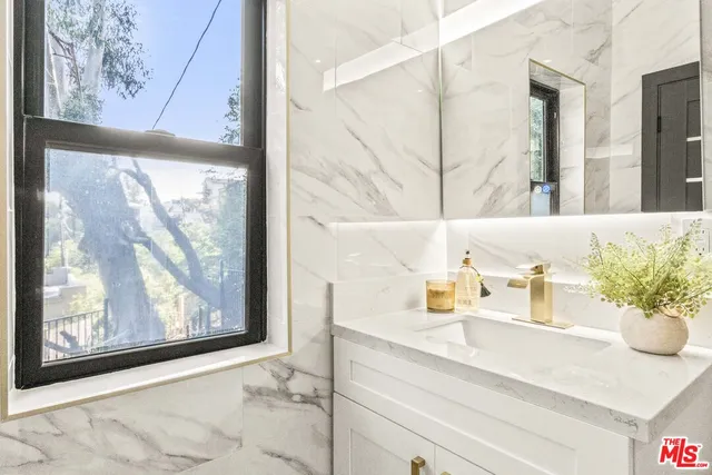 a view of a hallway with furniture and floor to ceiling window