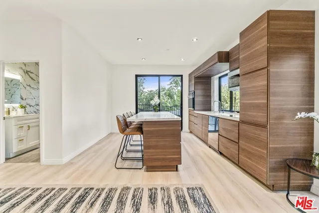 a dining room with furniture and large windows
