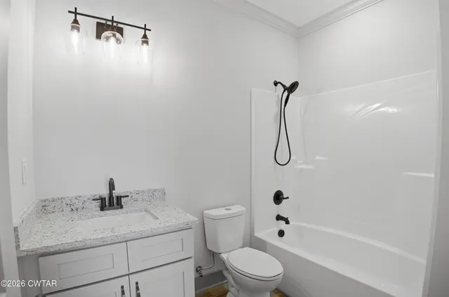 a bathroom with a granite countertop sink a toilet and shower